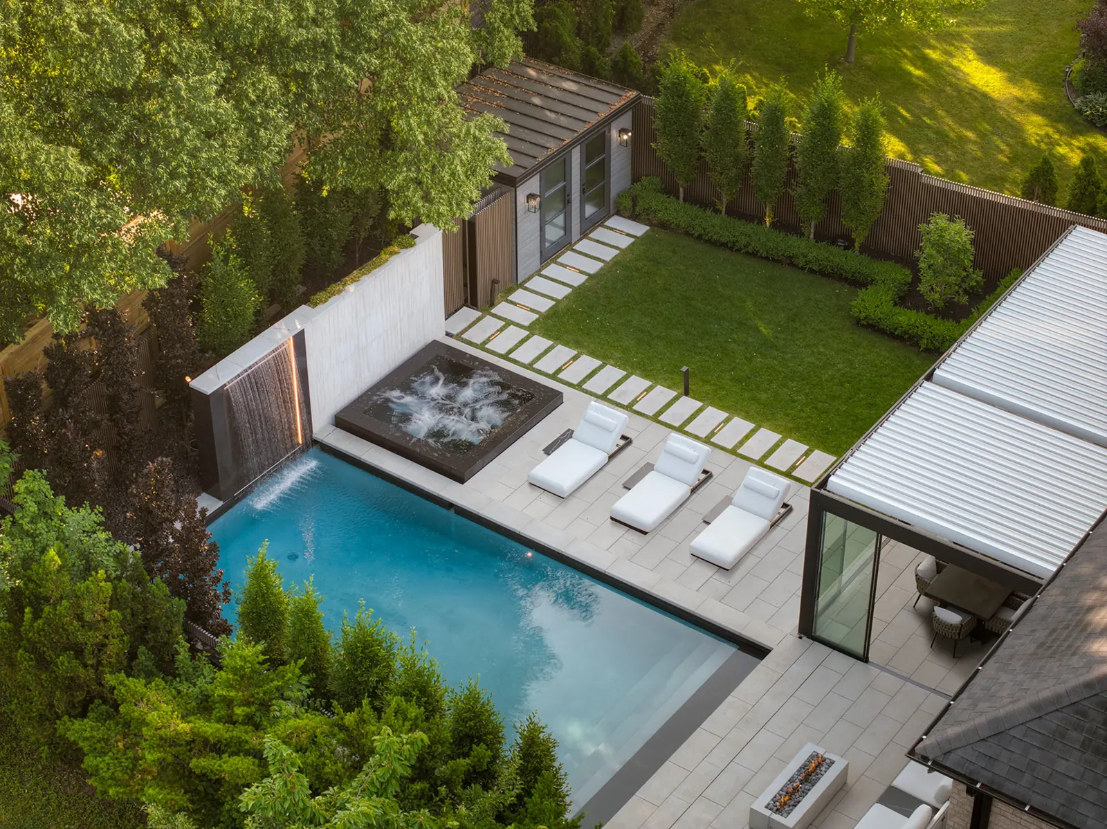 Finished backyard with Proma XL Whistler slabs, pool and pergola, aerial view