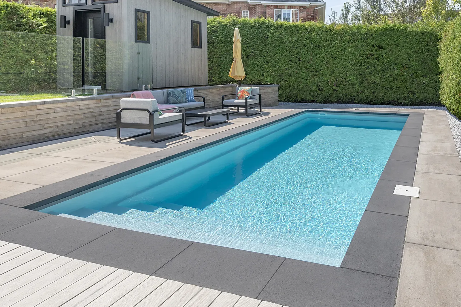 Proma XL caviar coping and slabs around a rectangular in-ground pool