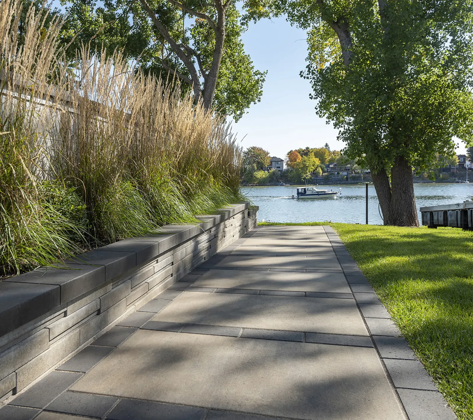 Solino wall in Oka beige with Solino truffle coping along a waterside walkway